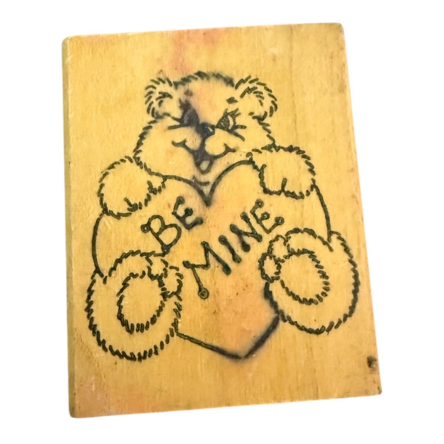 Wooden block Stamp with a bear holding a heart and 'Be Mine' text on a white background