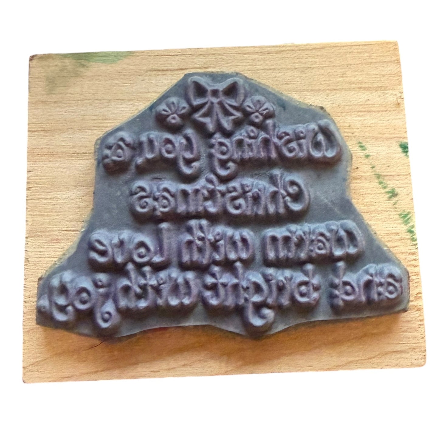 Wooden stamp with rubber engraved text on a wooden block