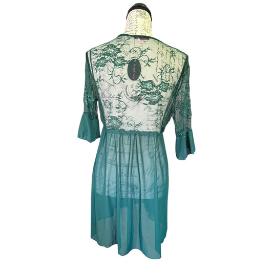 A green patterned sheer mesh babydoll displayed on a dress form against a white background, showing the back view with three-quarter sleeves and a gathered waist.
