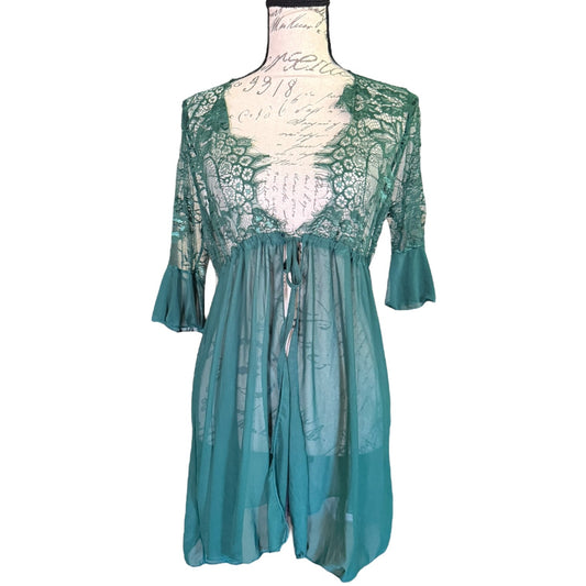 A green sheer lace babydoll nightgown with three-quarter sleeves and a tie waist, displayed on a cream-colored dress form against a white background.