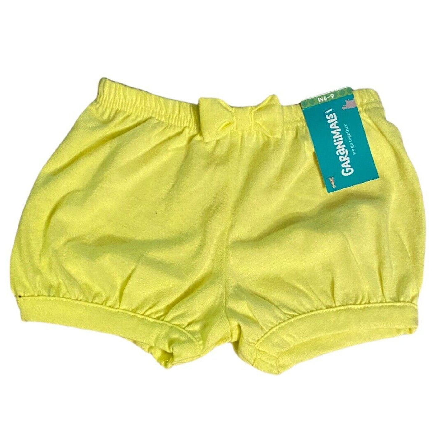 Bright yellow baby bloomers with an elastic waistband and a small bow, shown with a green and blue tag on a white background.