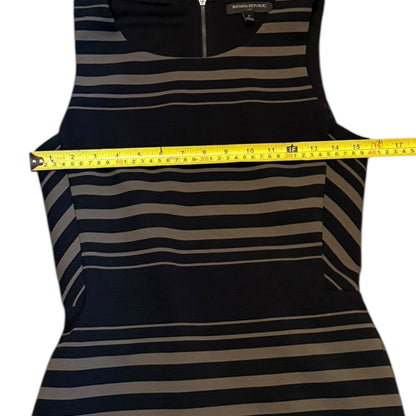Striped tank dress with a measuring tape draped over it on a white background