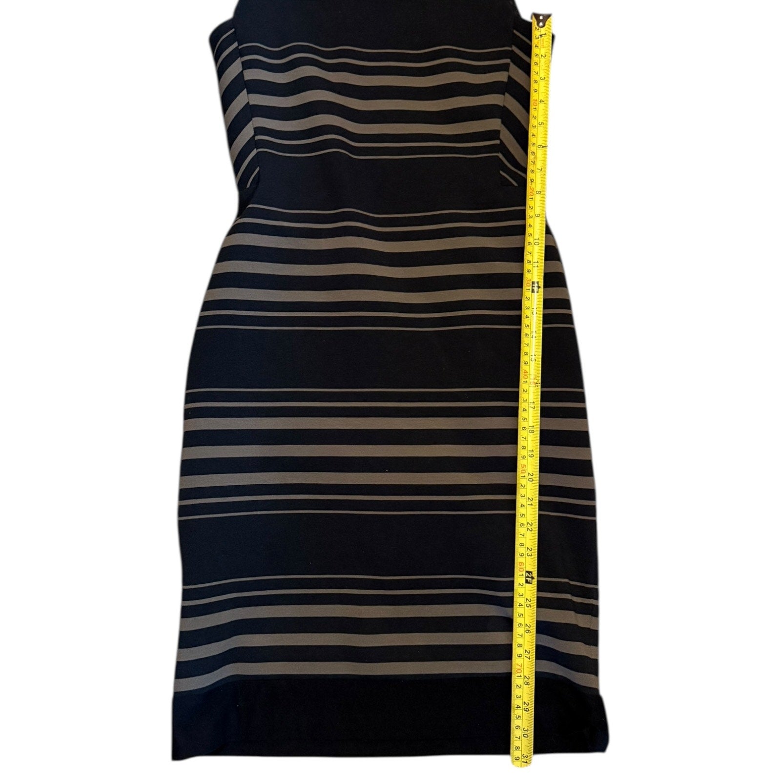 Striped dress with a measuring tape on a white background