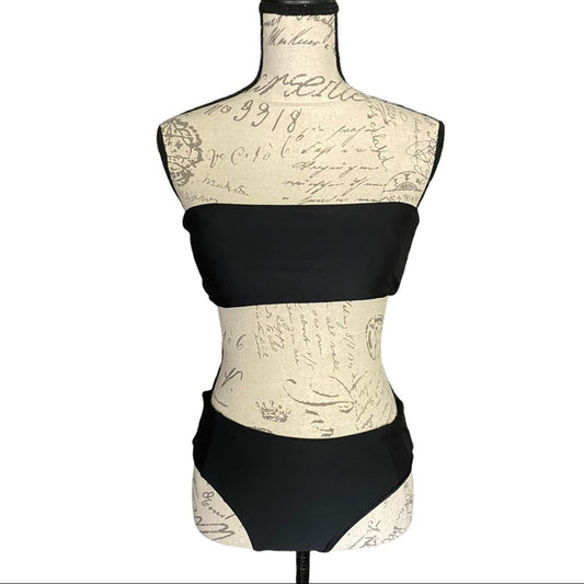 Front of Black swimsuit on a mannequin with a script patterned base.