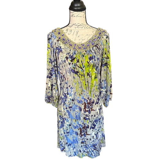 Front of Colorful floral dress on a mannequin against a white background