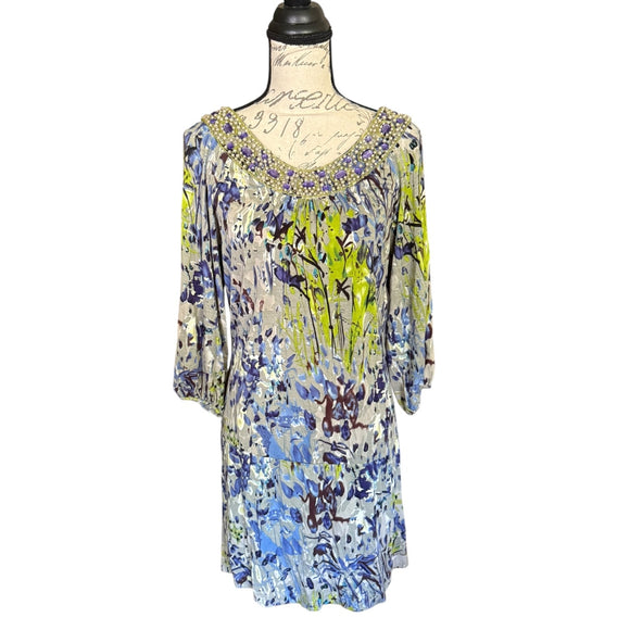 Front of Colorful floral dress on a mannequin against a white background