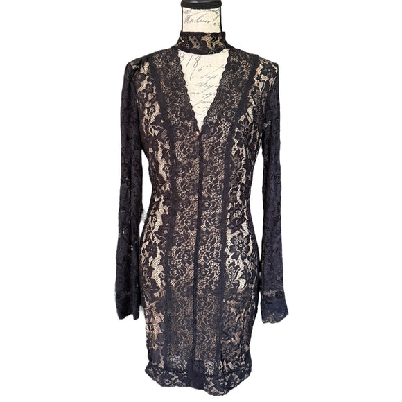 front of black lace dress on a mannequin against a white background