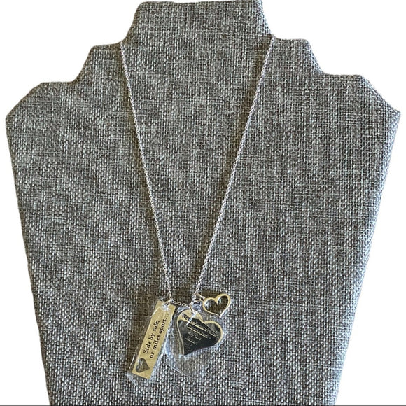 Necklace with two pendants on a gray mannequin