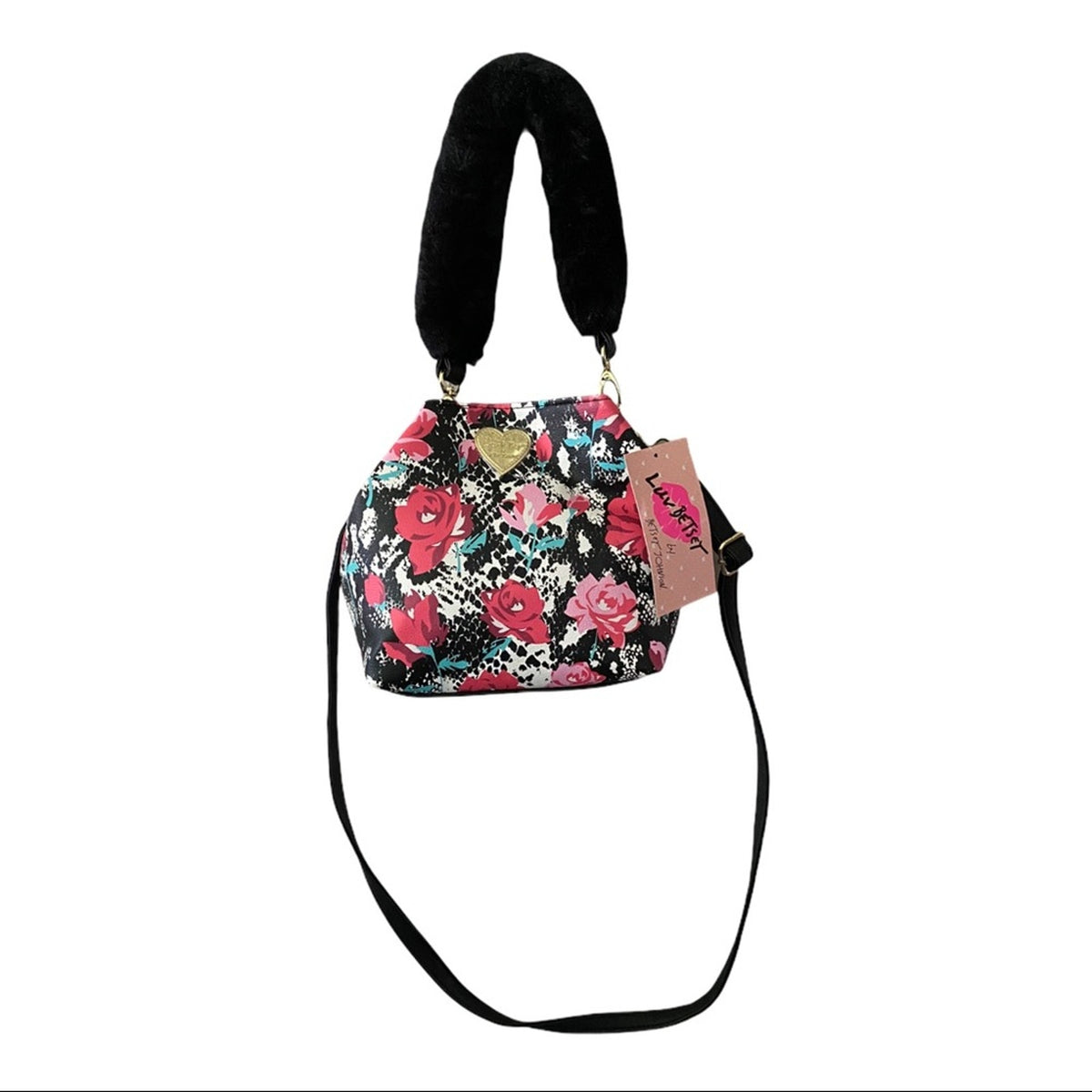 A small floral-patterned handbag with a black faux-fur handle, a black shoulder strap, and a pink brand tag.