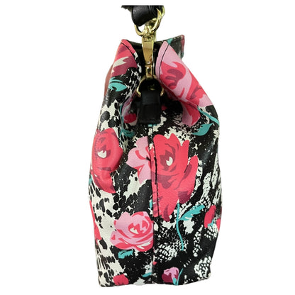 A side view of  with a black, pink, and red floral print, featuring a metal clasp and a black strap.
