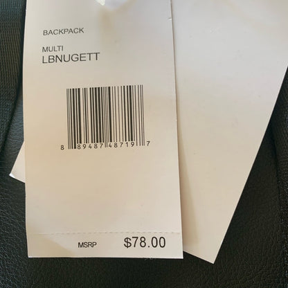A close-up of a white paper price tag attached to a backpack, showing the text 'BACKPACK MULTI LBNUGETT' and a barcode. The tag also shows an MSRP price of $78.