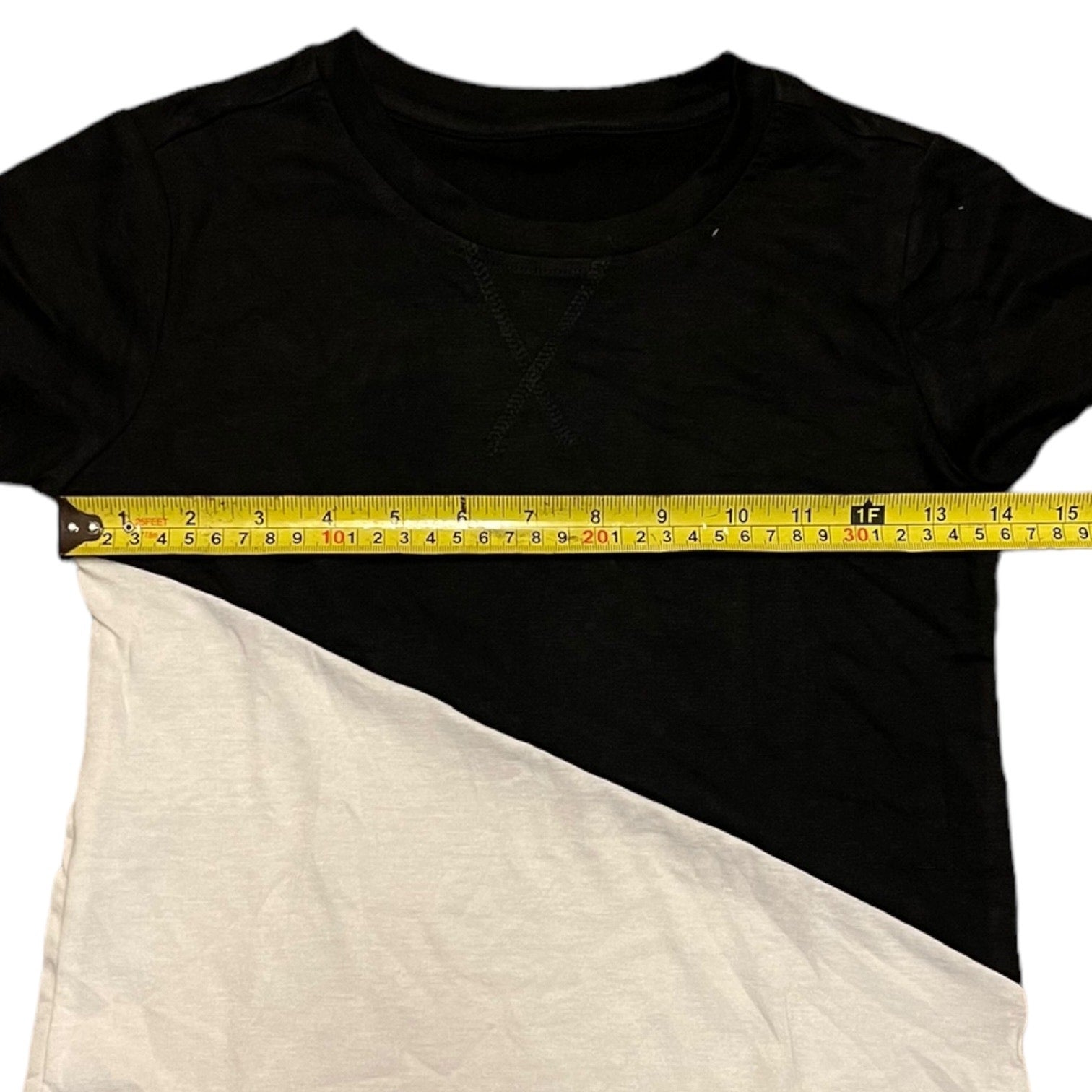 Black and white t-shirt with a measuring tape across the chest