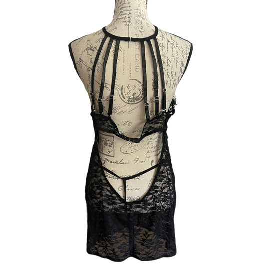 Back of Black lace lingerie set on a mannequin with a vintage-style background