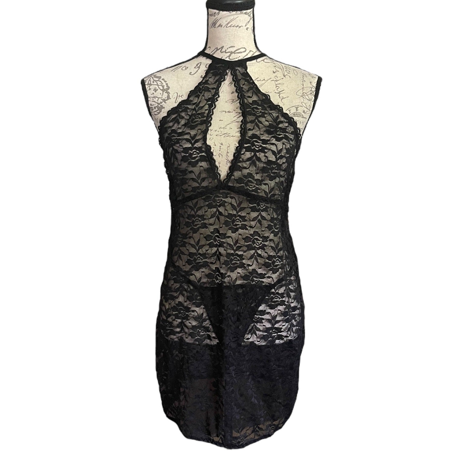 Black lace lingerie set on a mannequin against a white background
