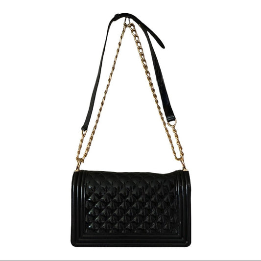Back of Black quilted handbag with a gold chain strap on a white background