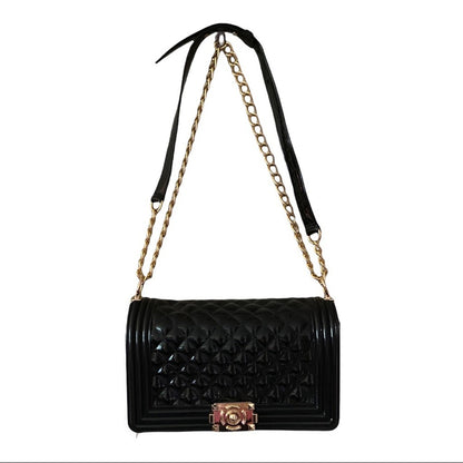 Front of Black quilted handbag with gold chain strap on a white background