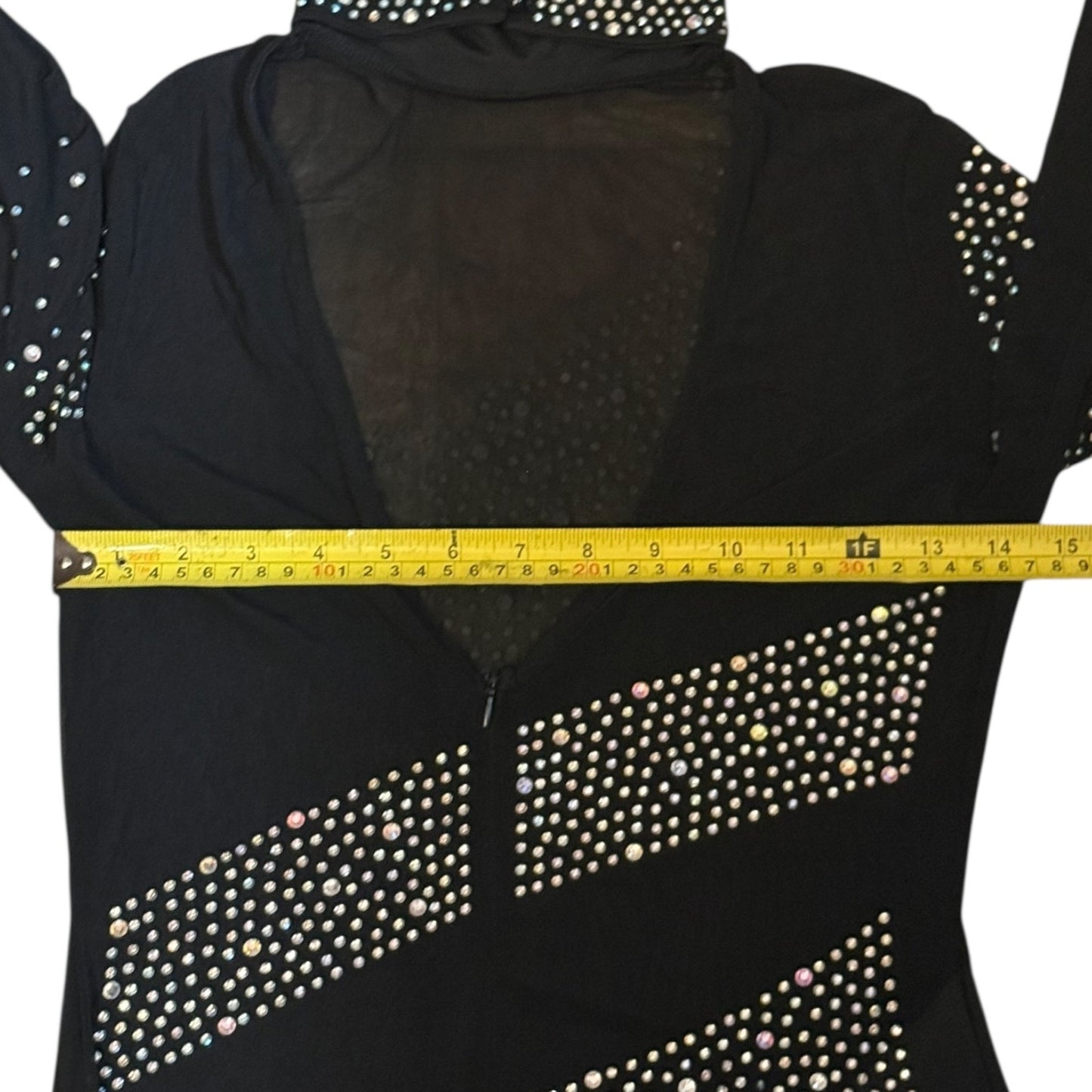 Black catsuit with rhinestone details being measured with a yellow tape measure.