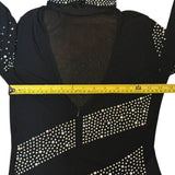 Black catsuit with rhinestone details being measured with a yellow tape measure.
