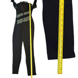 Black catsuit with a yellow measuring tape for size reference on a white background