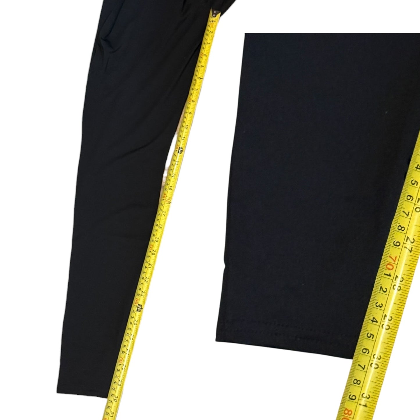 Black catsuit with a yellow measuring tape on a white background