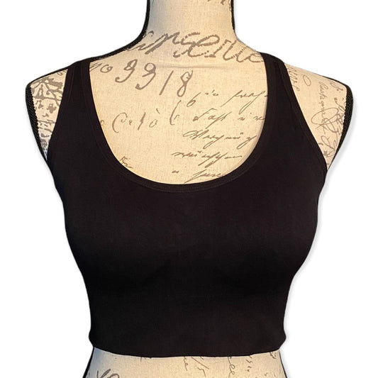 Front of black sports bra on a mannequin with a vintage-style script background