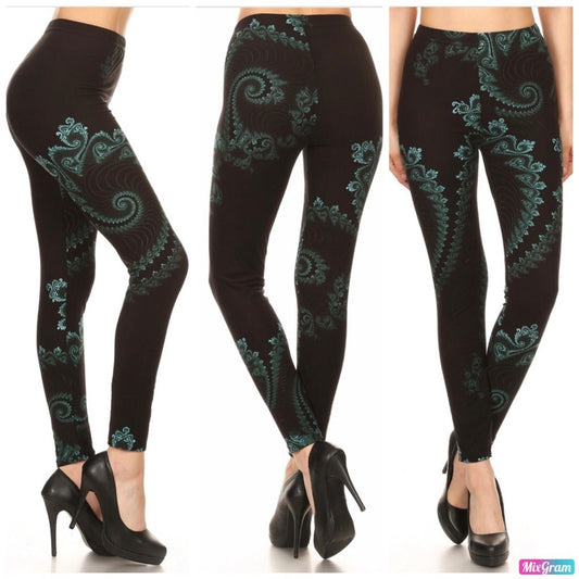 Black leggings with green patterns worn by a person on a white background