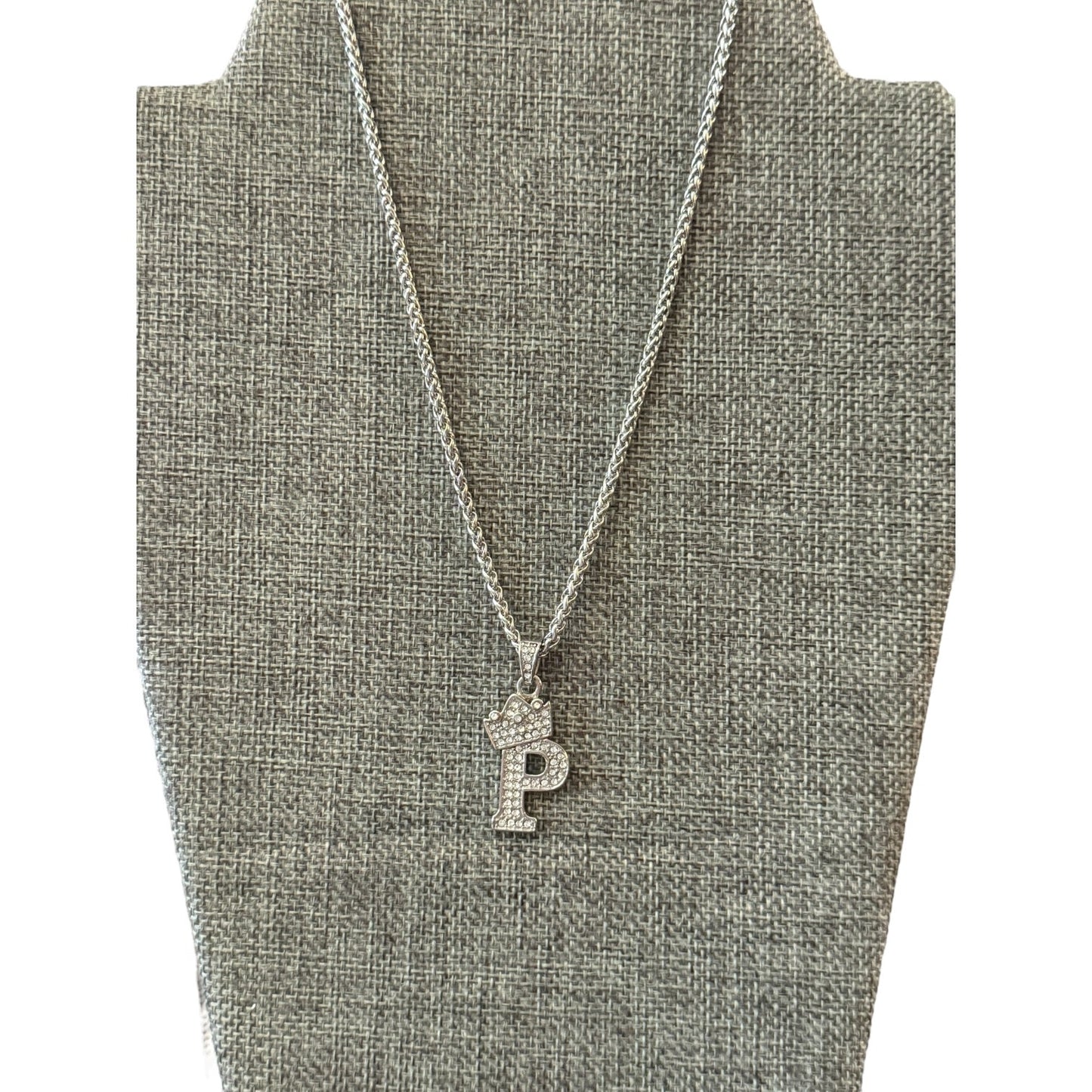 Necklace with a 'P' pendant on a gray bust