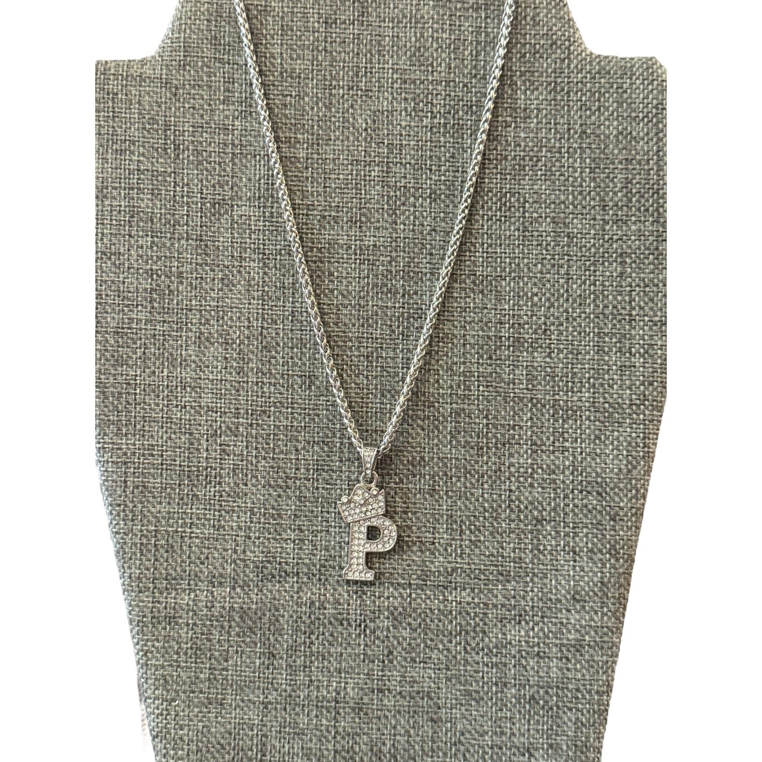 Necklace with a 'P' pendant on a gray bust