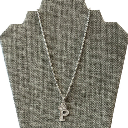 Silver necklace with a P pendant on a gray bust