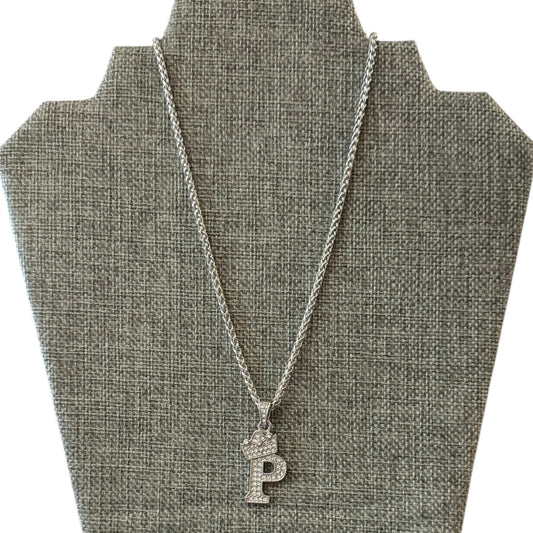 Silver necklace with a P pendant on a gray bust