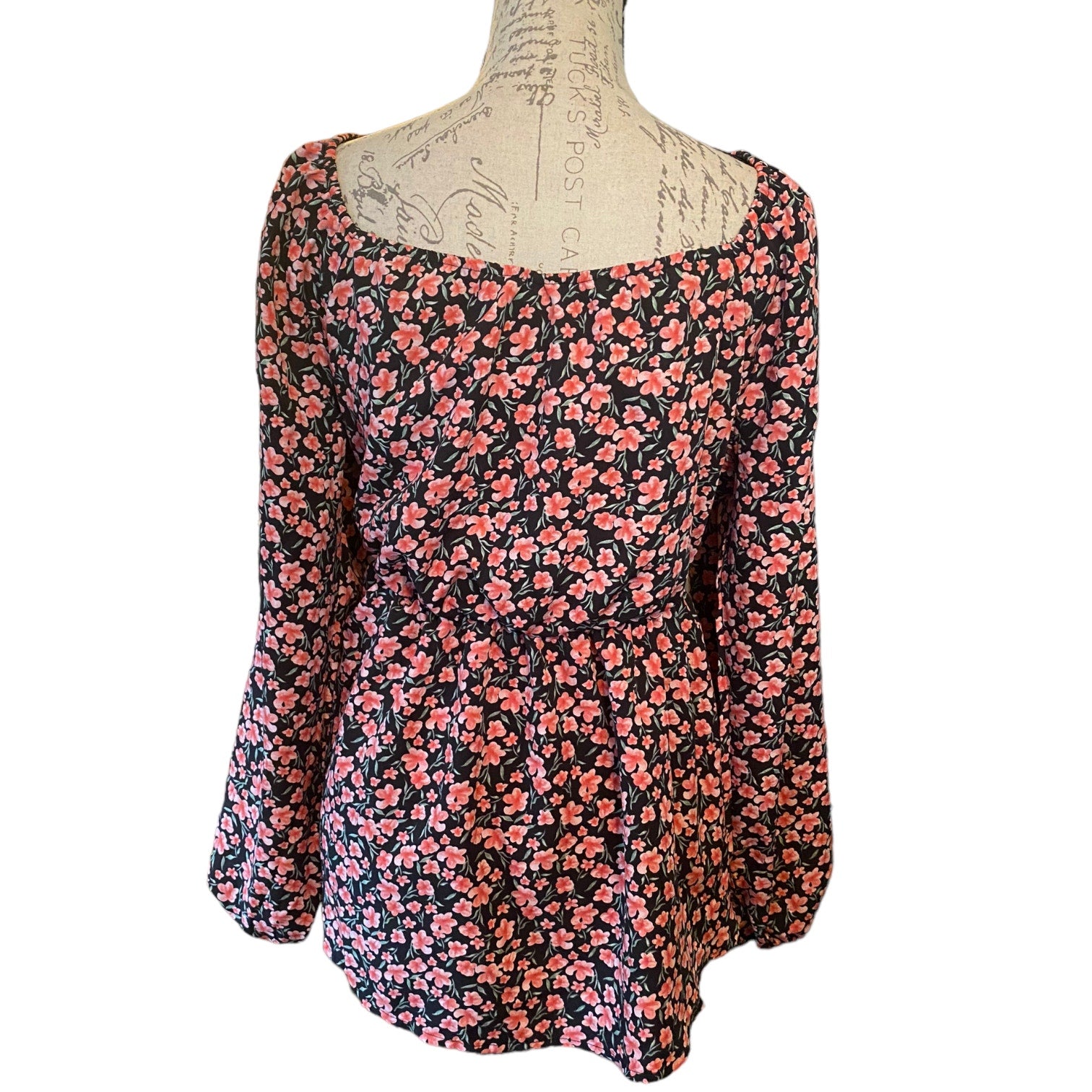 Back of pink and black shirt on a mannequin on a white back ground