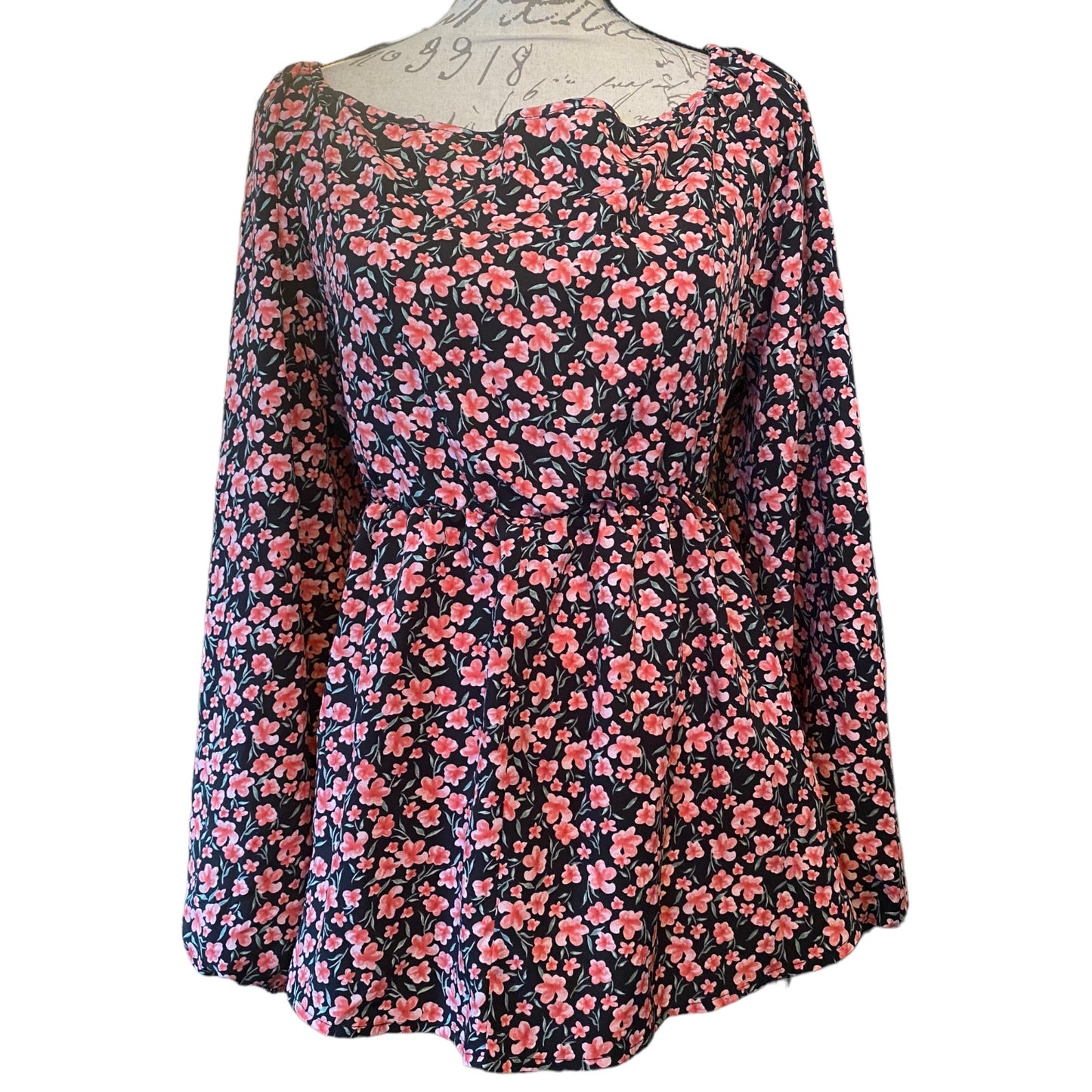 Front of pink and black shirt on a mannequin on a white background