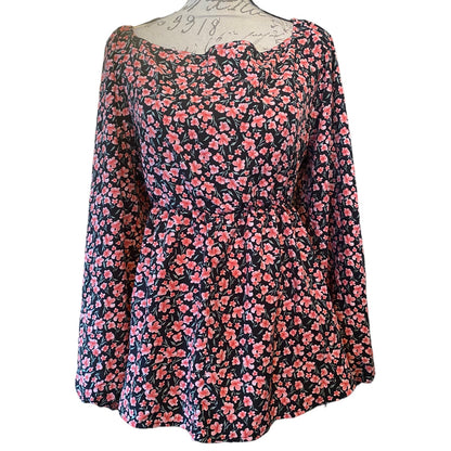 Front of pink and black shirt on a mannequin on a white background