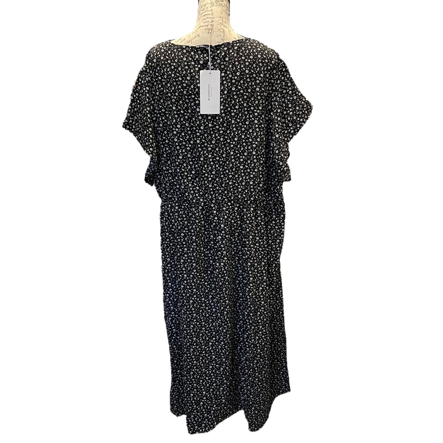 Back of Black floral dress on a mannequin with a white background