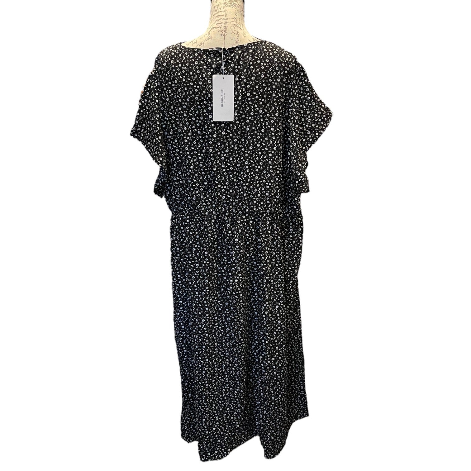 Back of Black floral dress on a mannequin with a white background