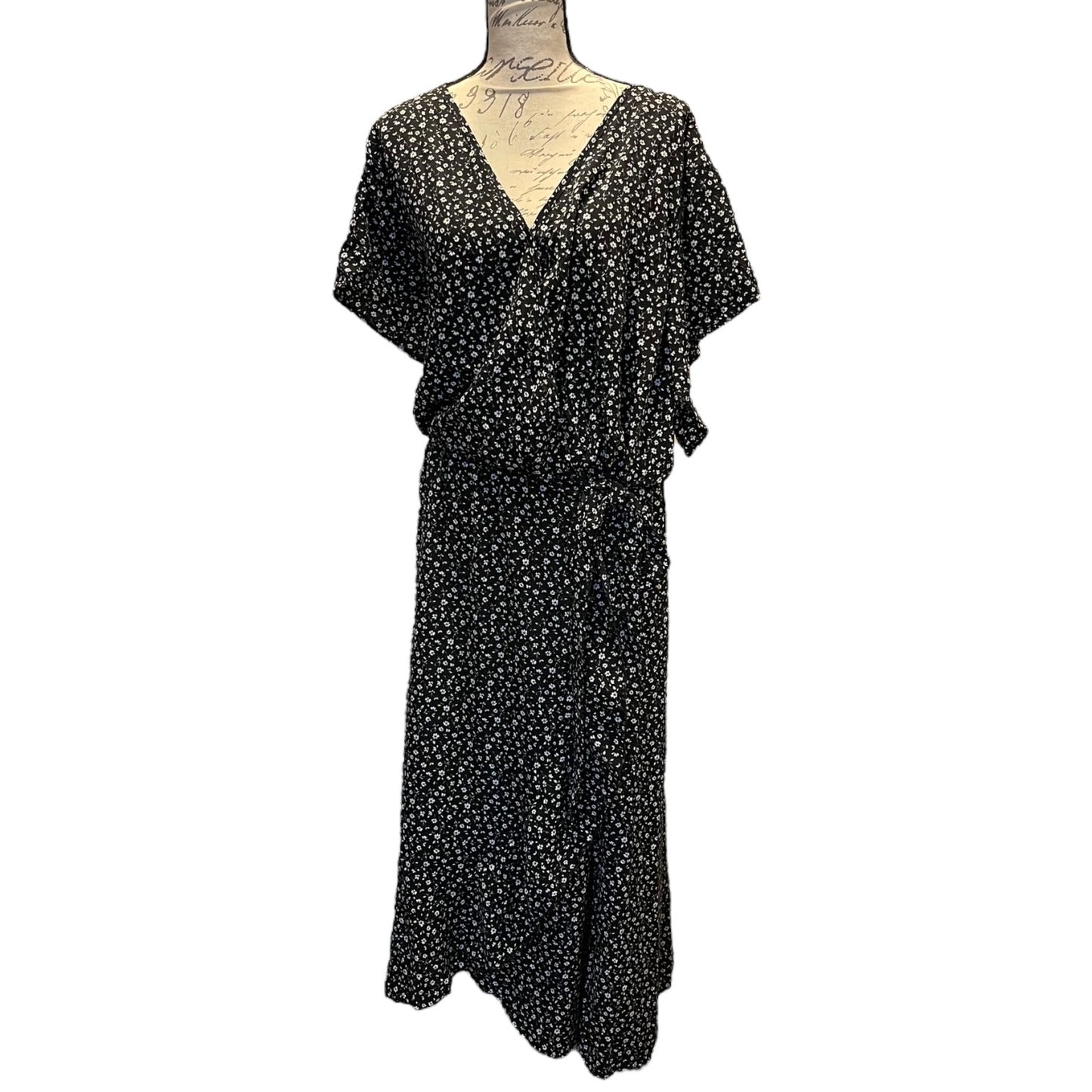 Front of Black dress with white floral pattern on a mannequin against a white background