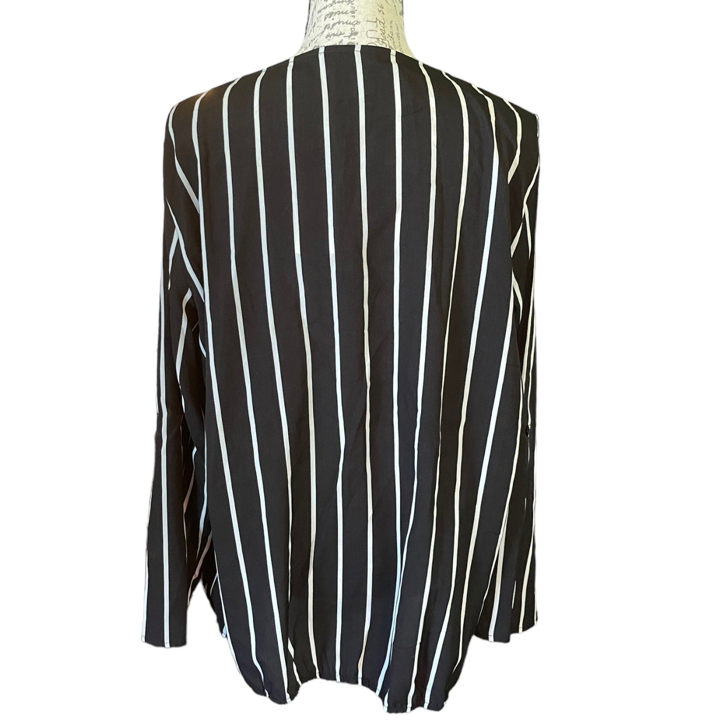 Back of Black and white striped shirt on a mannequin with a white background