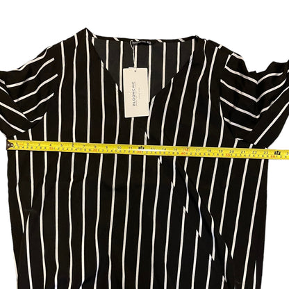 Black and white striped shirt with a measuring tape and tag on a white background