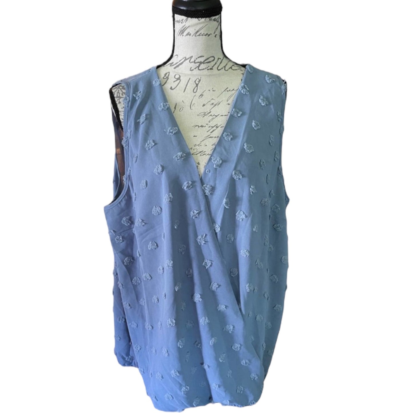 Blue sleeveless top on a mannequin with a white background