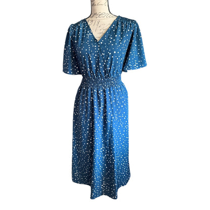 Front of Blue dress with white polka dots on a mannequin against a white background