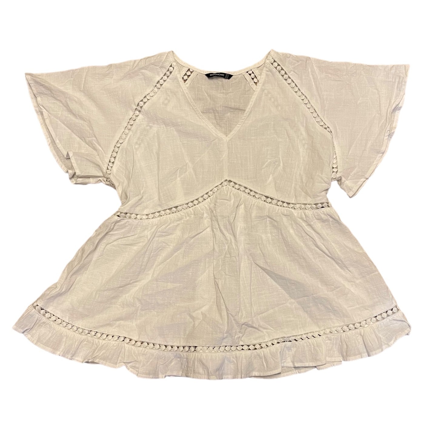 White shirt laying flat with short sleeves  on a white background