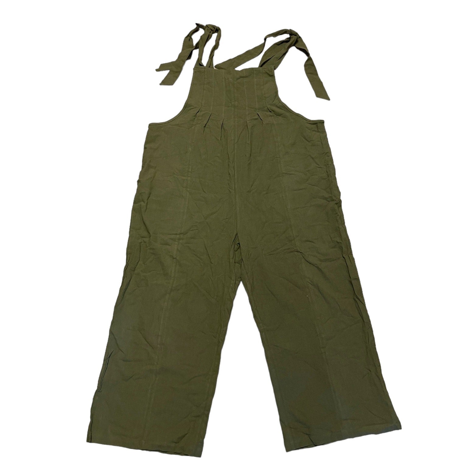 Green overalls with straps laying flat on a white background