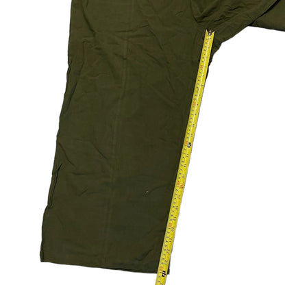 Inseam on green overalls on a white background