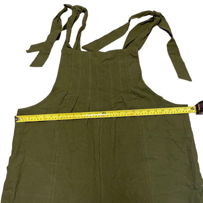 Green overalls with a measuring tape across it on a white background