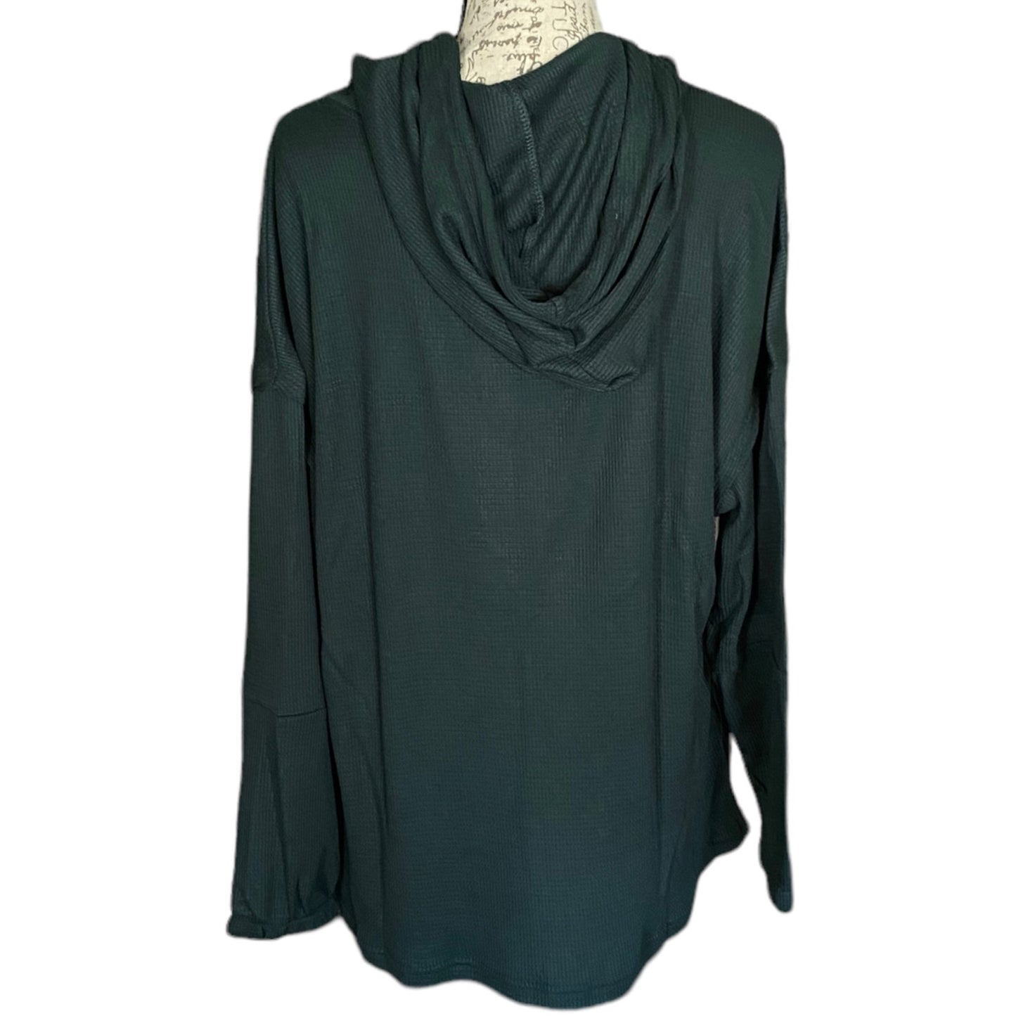 Dark green long-sleeve top on a mannequin with a white background