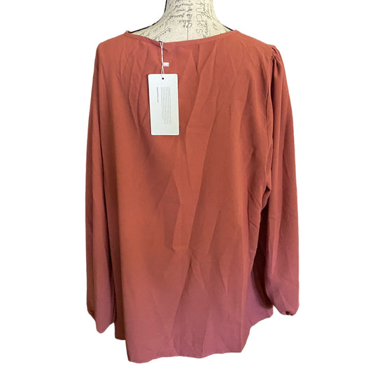 A long-sleeve top displayed on a dress form mannequin against a white background, with a white product tag still attached.