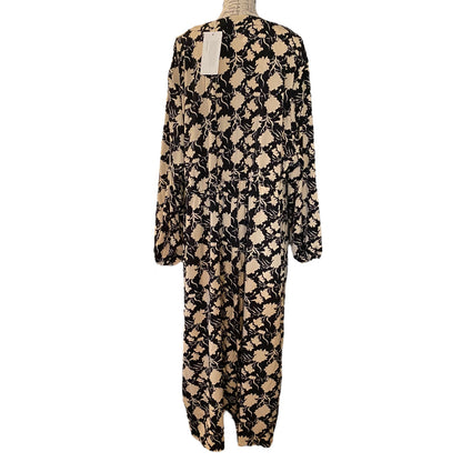 A long-sleeve dress with an all-over abstract floral pattern in beige and black, displayed on a dress form against a white background.