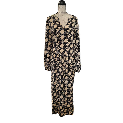 A long-sleeve dress with a black and beige abstract floral pattern, displayed on a dress form mannequin against a plain white background.