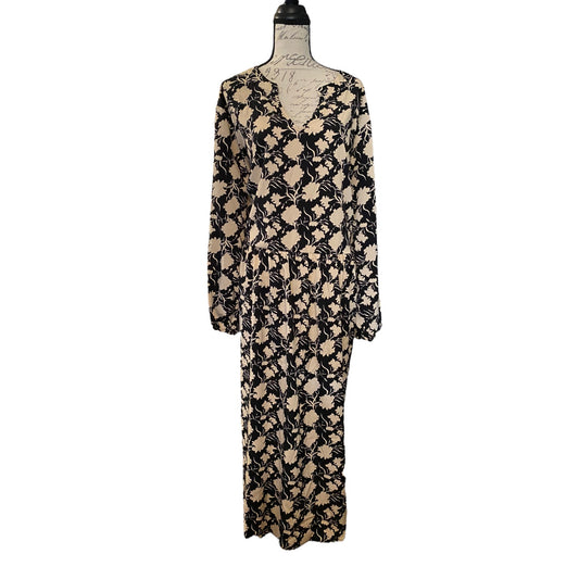A long-sleeve dress with a black and beige abstract floral pattern, displayed on a dress form mannequin against a plain white background.