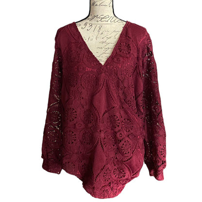 Red lace top on a mannequin with a white background